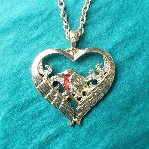 2/10$ Gold tone wing heart with a red bird pendant